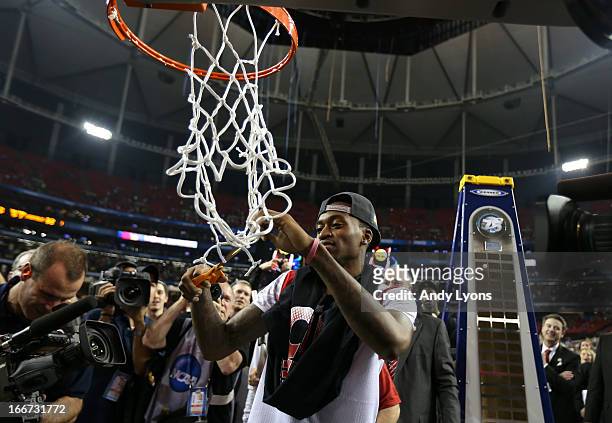 Injured guard Kevin Ware of the Louisville Cardinals cuts down the net in celebration of Louisville defeating the Michigan Wolverines during the 2013...
