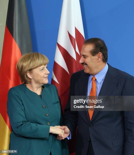 German Chancellor Angela Merkel and Qatar Prime Minister Hamad bin Jassim Al Thani depart after speaking to the media following talks at the...