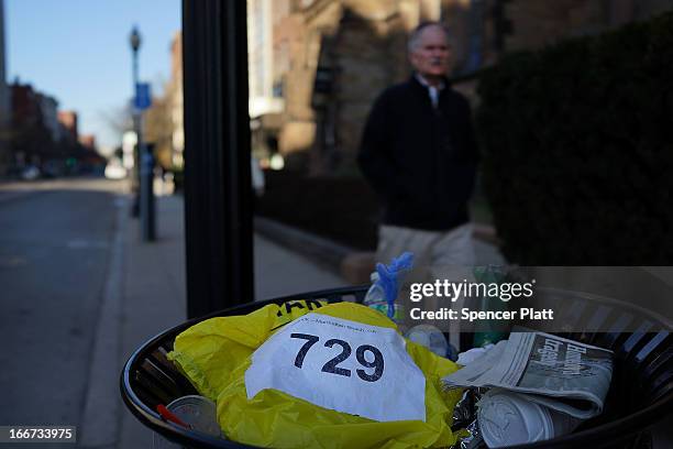 Discarded runners bib is viewed near the scene of a twin bombing at the Boston Marathon on April 16, 2013 in Boston, Massachusetts. The twin...