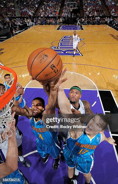 Xavier Henry and Lou Amundson of the New Orleans Hornets battles for the rebound against DeMarcus Cousins of the Sacramento Kings on April 10, 2013...