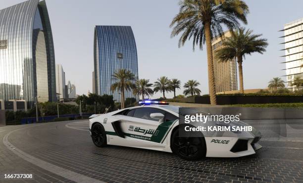 Emirati policemen patrol in an especially modified Lamborghini Aventador on April 16, 2013 in the Gulf emirate of Dubai. The introduction of the...