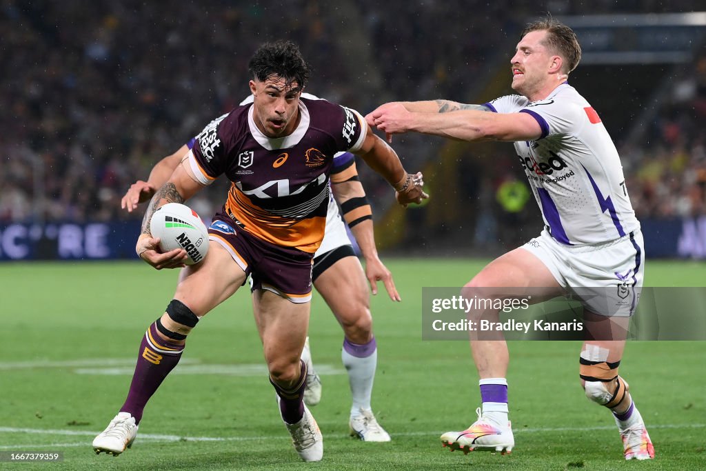 John Radel Nrl Kotoni Staggs of the Broncos breaks a tackle to score a try during ...