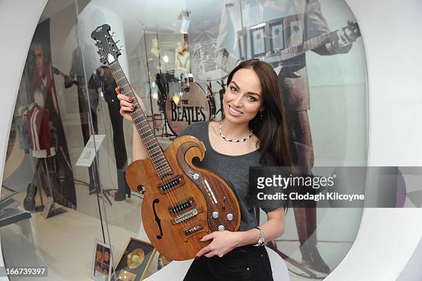 Model, Daniella Moyles displays a rare Vox guitar played by George Harrison and John Lennon which is exhibited at the Newbridge Silverware Museum of...