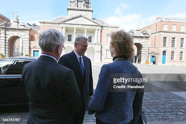 In this handout image provided by the Dept of the Taoiseach, Former Vice President of the United States, Al Gore is welcomed to Dublin Castle by...