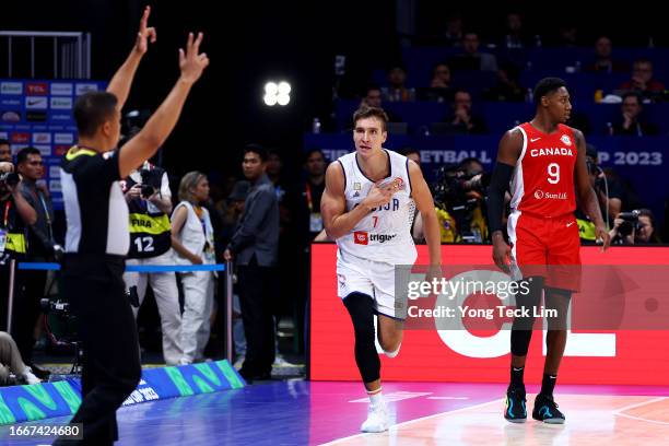 Bogdan Bogdanovic of Serbia celebrates after scoring a three-pointer against RJ Barrett of Canada in the fourth quarter during the FIBA Basketball...