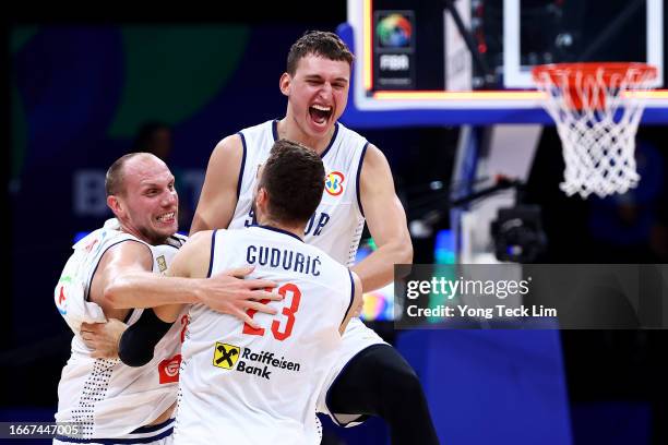 Dejan Davidovac, Marko Guduric and Nikola Jovic of Serbia celebrate after the FIBA Basketball World Cup semifinal game victory over Canada at Mall of...