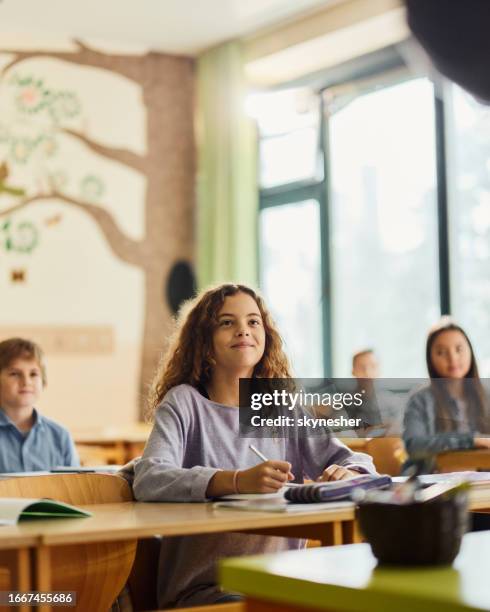 smiling elementary student on a class at school. - edifício escolar imagens e fotografias de stock