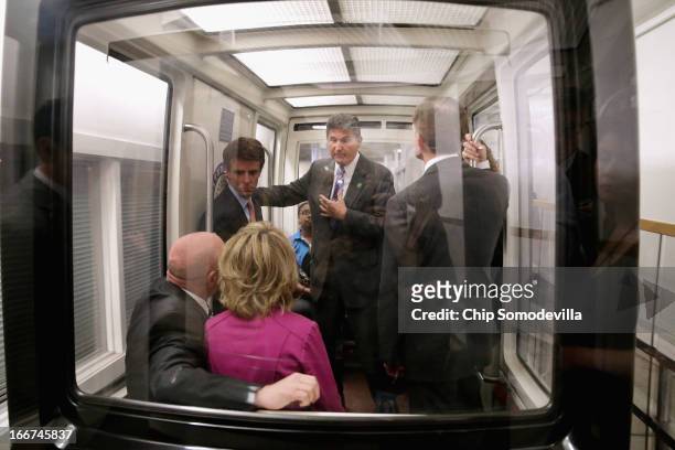 Sen. Joe Manchin talks with shooting victim and former Rep. Gabrielle Giffords and her husband and retired astronaut Mark Kelly while riding the...