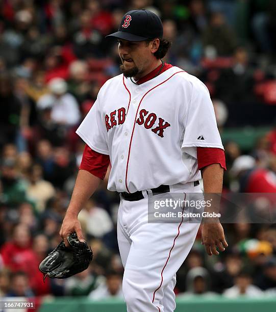 Boston Red Sox relief pitcher Joel Hanrahan walks the long walk to the Sox dugout amidst a round of boos from the stands after he was lifted in the...