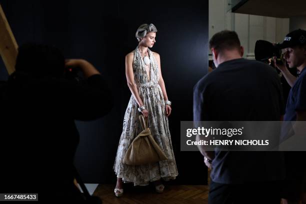 Model gets ready backstage before Irish designer Paul Costelloe's catwalk presentation for his Spring/Summer 2024 collection during London Fashion...