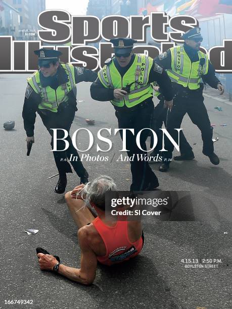 April 22, 2013 Sports Illustrated via Getty Images Cover: Track & Field: Boston Marathon: Police officers draw their guns drawn after hearing the...