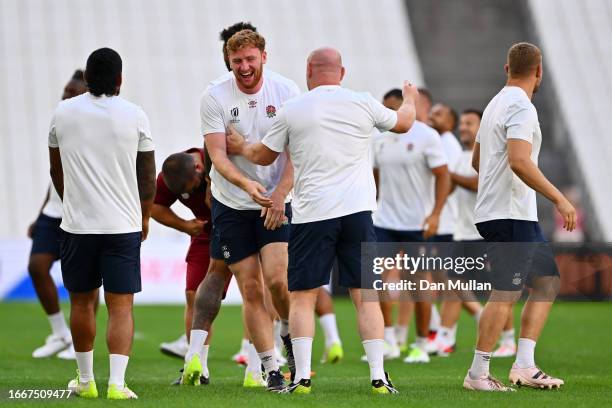 Ollie Chessum of England shares a joke with Dan Cole of England during the Captain's Run ahead of their Rugby World Cup France 2023 match against...
