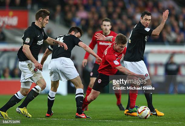 Aron Gunnarsson of Cardiff City competes with Dorian Dervite, Jonnie Jackson and Andy Hughes of Charlton Athletic during the npower Championship...