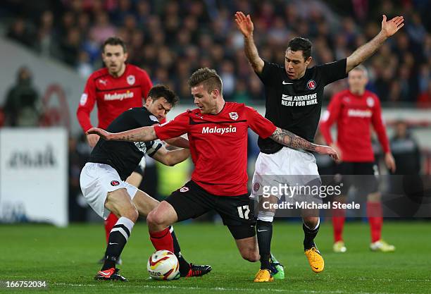 Aron Gunnarsson of Cardiff City competes with Jonnie Jackson and Andy Hughes of Charlton Athletic during the npower Championship match between...
