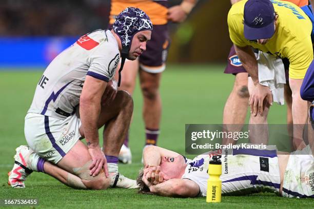 Ryan Papenhuyzen of the Storm is attended to by a team trainer after an ankle injury during the NRL Qualifying Final match between the Brisbane...