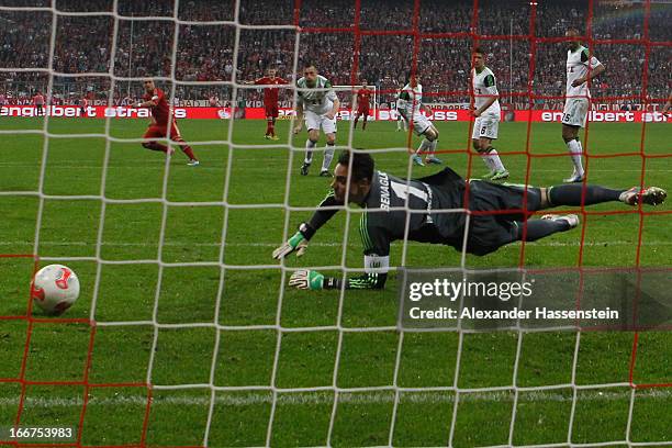 Xherdan Shaqiri of Muenchen scores the 3rd team goal against keeper Diego Benaglio of Wolfsburg during the DFB Cup Semi Final match between Bayern...