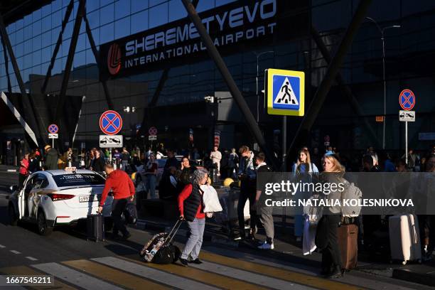 Passengers wait for their taxis at Moscow's Sheremetyevo International Airport on September 14, 2023.