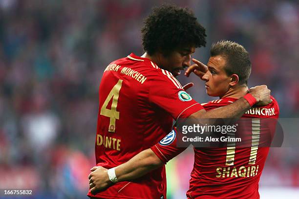 Xherdan Shaqiri of Muenchen celebrates his team's third goal with team mate Dante during the DFB Cup Semi Final match between Bayern Muenchen and VfL...