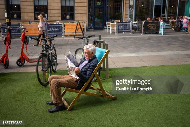 Man sits in a deckchair reading the paper in Newcastle city centre on September 08, 2023 in Newcastle Upon Tyne, England.