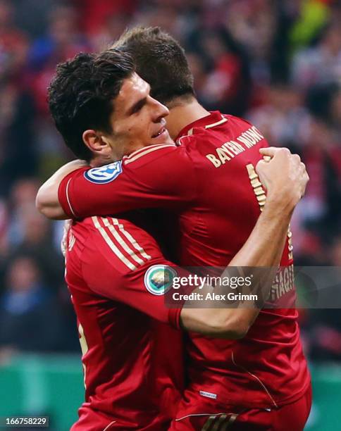 Mario Gomez of Muenchen celebrates his team's fourth goal with team mate Xherdan Shaqiri during the DFB Cup Semi Final match between Bayern Muenchen...