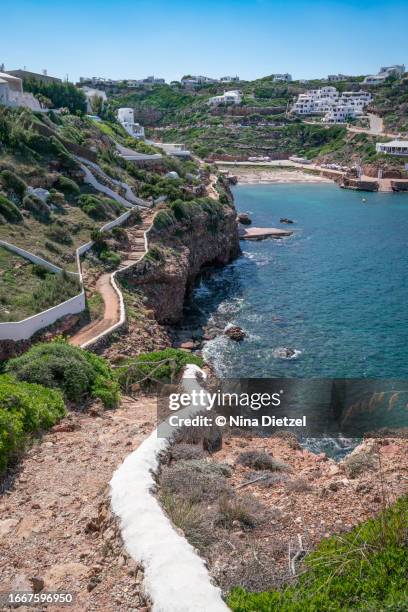 coastal path down to the beach, cala morell, minorca - menorca stockfoto's en -beelden