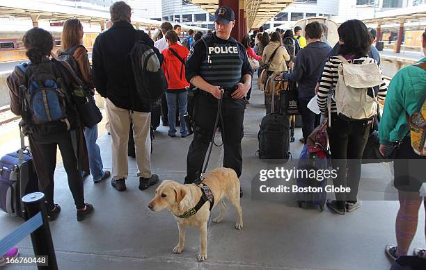 Amtrak police officer Joe Agnellino and his bomb detection dog "Roxy" check passengers before they board a train at South Station.
