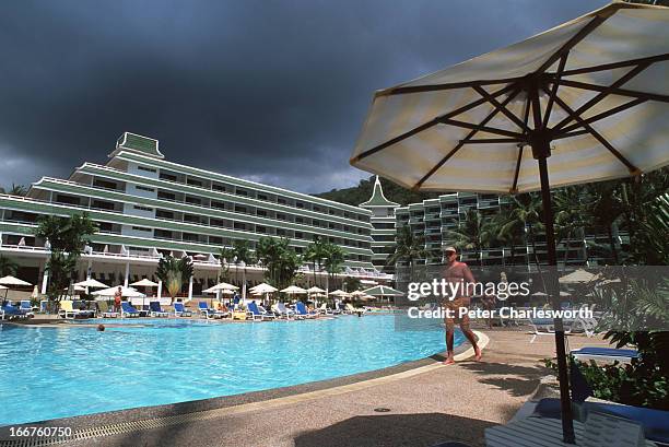 Large umbrella stands in front of the giant swimming pool at Le Meridien Hotel on Karon Noi Beach..