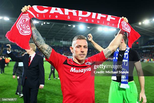 Craig Bellamy of Cardiff City celebrates his team's promotion to the Premier League at the end of the npower Championship match between Cardiff City...