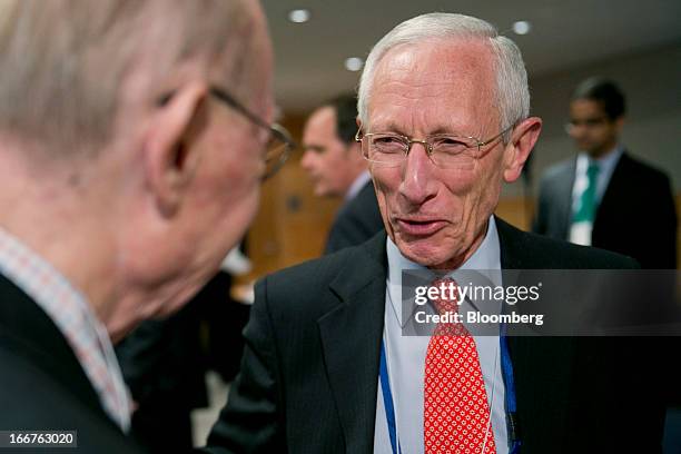 Stanley Fischer, governor of the Bank of Israel, right, talks to Allan Meltzer, university professor of political economy at Tepper School of...