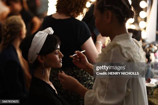 Model gets ready backstage before Irish designer Paul Costelloe's catwalk presentation for his Spring/Summer 2024 collection during London Fashion...