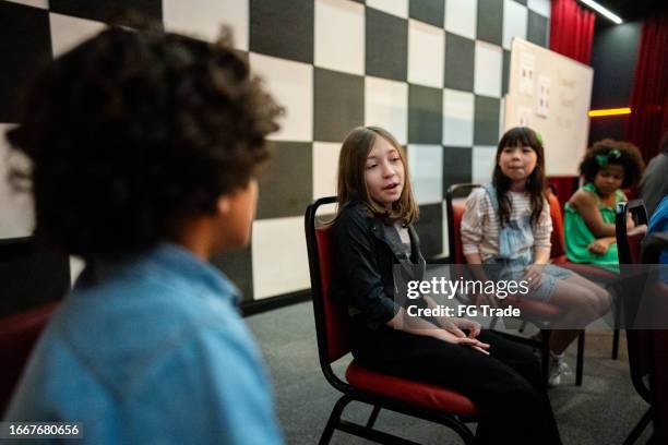 children talking while waiting in a music contest - behind the scenes interview stock pictures, royalty-free photos & images