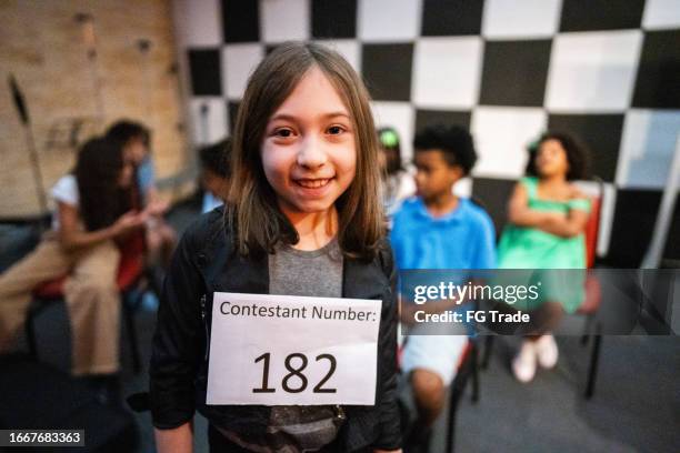 portrait of a girl with identification number in a music contest - looking at camera celebrity stock pictures, royalty-free photos & images