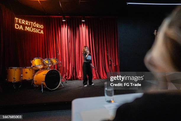 girl singing in a music contest - kids-singing-on-stage stock pictures, royalty-free photos & images