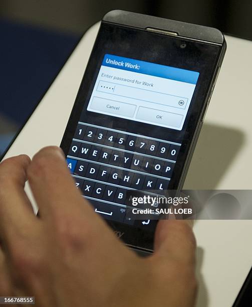 Technology representative demonstrates the Blackberry Z10 smartphone using Blackberry 10 operating system during CES on the Hill on Capitol Hill in...