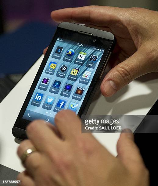 Technology representative demonstrates the Blackberry Z10 smartphone using Blackberry 10 operating system during CES on the Hill on Capitol Hill in...