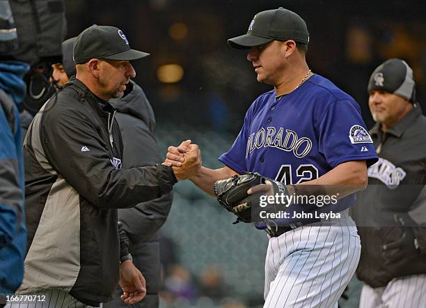 Walt Weiss, manager of the Colorado Rockies shakes hands with Rafael Betancourt after their win over the New York Mets April 16, 2013 at Coors Field....