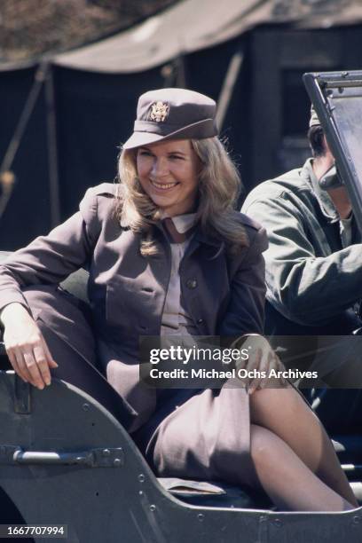 Loretta Swit sitting in a jeep during the filming of television show M*A*S*H, United States, August 1976. She plays the character Maj. Margaret "Hot...
