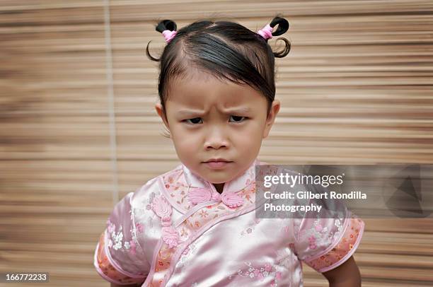 angry little girl wearing cheongsam - squinting stock pictures, royalty-free photos & images