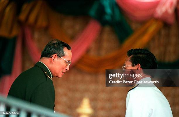 His Majesty, King Bhumibol Adulyadej of Thailand, talks to his Prime Minister, Chuan Leekpai during the opening ceremony of the Pa Sak Jolasid Dam, a...