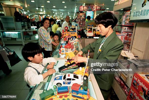Children and their parents shop for toys in a government department store on Nanjing road..
