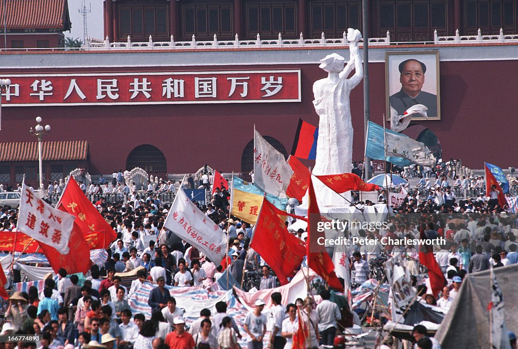 The "Goddess of Democracy" stands tall amid a huge crowd of...