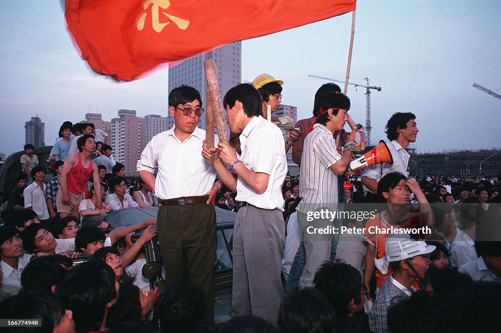 Pro-democracy demonstrators stand on the front of a Chinese...