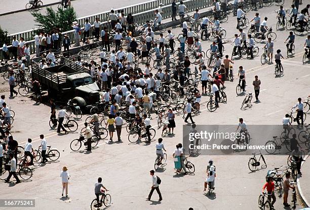 At the end of the pro-democracy movement in China. Onlookers view Chinese Army trucks and vehicles that were damaged or destroyed during the night of...