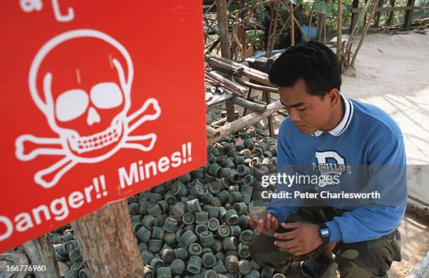 Aki Ra outside the Landmine Museum that he built near Siem Reap. On display in the garden are hundreds of anti-tank and anti-personnel land mines as...