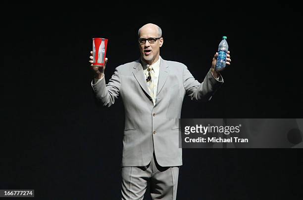 President and CEO of the National Association of Theatre Owners John Fithian holds up a 44-ounce Coca-Cola cup and a bottle of Dasani water in...