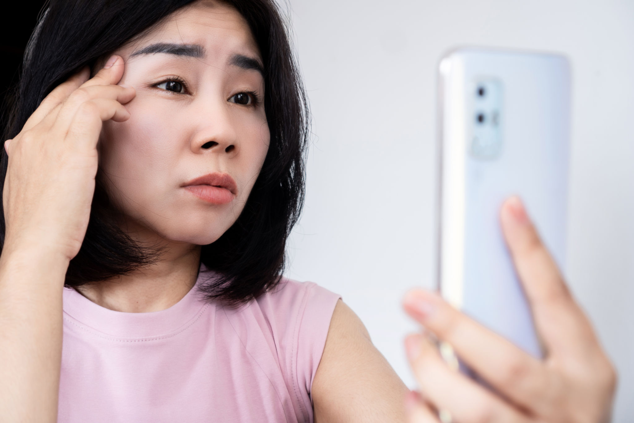 asian woman have problem with blurry and tired eye discomfort to read on mobile phone asian woman have problem with blurry and tired eye discomfort to read on mobile phone