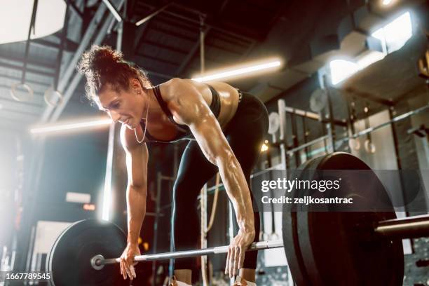 young woman in cross training gym - tough woman stock pictures, royalty-free photos & images