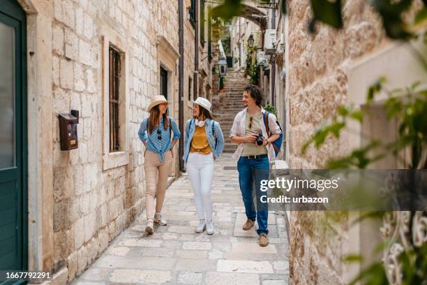 three young friends walking in an alley in dubrovnik - dubrovnik old town stock pictures, royalty-free photos & images