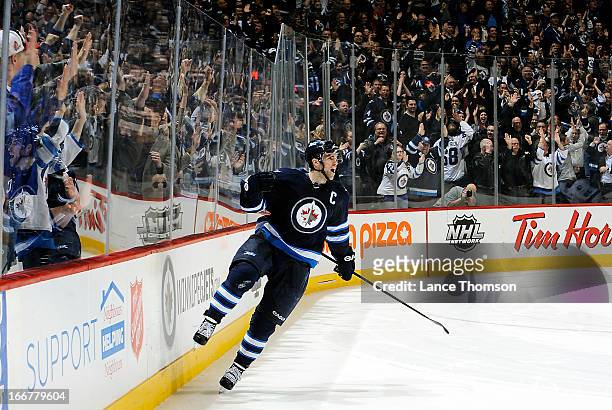 Andrew Ladd of the Winnipeg Jets celebrates his winning shootout goal against the Tampa Bay Lightning in front of fans at the MTS Centre on April 16,...