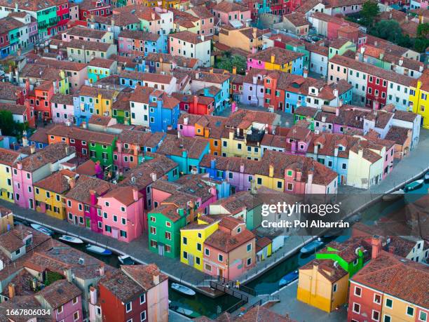 aerial evening view of vibrant house facades on burano island, a popular tourist destination in the venetian lagoon, italy - burano island stock pictures, royalty-free photos & images
